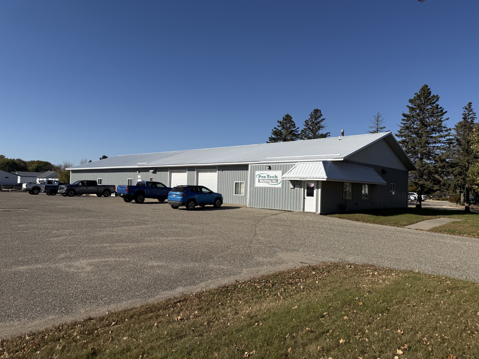 The ProTech Machining building in Litchfield, with the office entrance and the shop's overhead doors